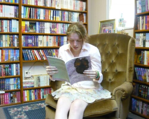 Photo of an author reading a book aloud