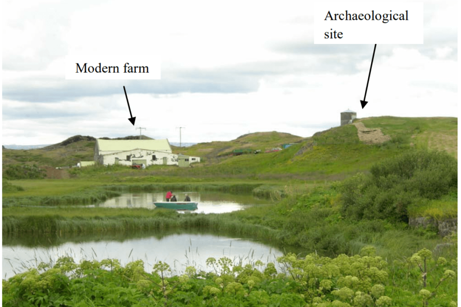 Photo of Icelandic countryside, featuring a farm, an archaeological site, and two lakes with some people in a boat.