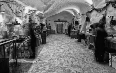 Photo of Climate scientists processing ice core samples in the EastGRIP science trench 10 m under the surface of the Greenland ice cap.