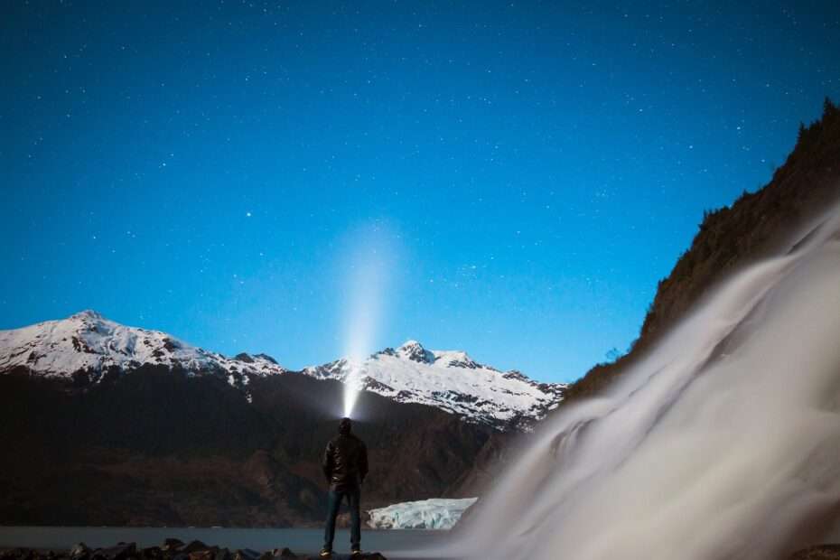 Photo of a man wearing a head torch in the mountains