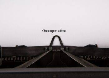 Photo of an old typewriter with a piece of paper saying Once upon a time