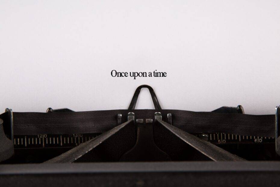 Photo of an old typewriter with a piece of paper saying Once upon a time